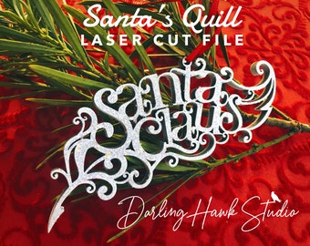 May include: A silver glitter laser cut file of a feather with the words "Santa Claus" written on it. The file is labeled "Santa's Quill Laser Cut File" and "Darling Hawk Studio".
