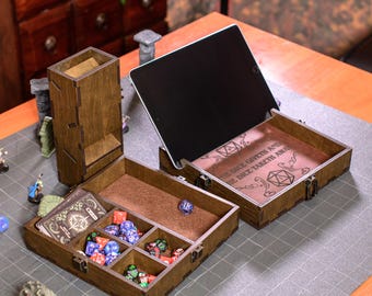 May include: Wooden dice rolling and storage set with a dice tower, two storage boxes, and an open tablet. The boxes are divided into compartments and contain dice and cards. The set is brown with a dark interior and is designed for tabletop gaming.