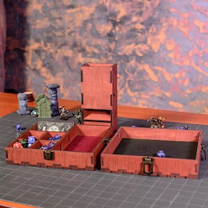 May include: A wooden dice rolling tower and storage box set in a reddish-brown finish. The set includes a tower, a dice tray, and a storage compartment with multiple sections. Dice and miniature figurines are also visible.