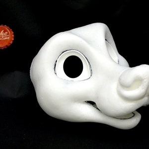 Puede incluir: Máscara de cabeza de animal peluda blanca sin pintar con detalles negros en los ojos. La máscara tiene una nariz grande y redonda y una boca ancha y abierta.