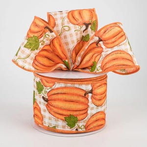 May include: A spool of orange and white ribbon with a pumpkin print. The ribbon is 2.5 inches wide and has a wired edge.