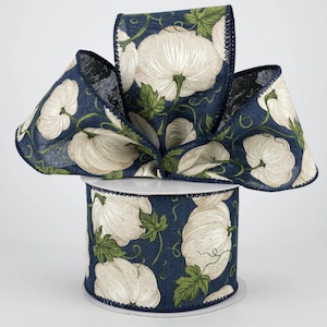 May include: A spool of 2.5 inch wide navy blue ribbon with a white pumpkin pattern. The ribbon is made of a burlap-like material and has a wired edge.