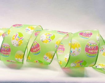 May include: Green satin ribbon with a repeating pattern of pastel pink and yellow Easter eggs with the text "Happy Easter" on some of the eggs.