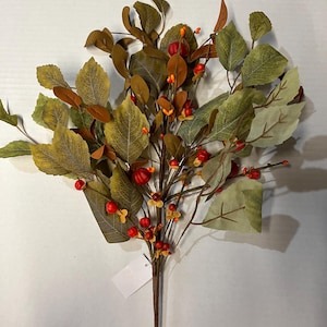 May include: Artificial fall foliage arrangement featuring green and brown leaves, and red berries. The stem is brown, and the leaves have a textured appearance. A blank white tag is attached to the stem. This decorative piece is suitable for autumn-themed decor.