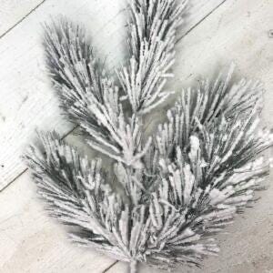 May include: A snowy artificial pine branch with green needles and a white frosted finish. The branch is perfect for adding a touch of winter to your home decor.