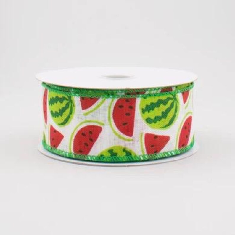 May include: A spool of white ribbon with a green edge and a repeating pattern of red and green watermelon slices.