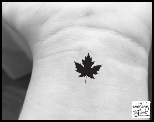 Small maple leaf tattoo located on the back