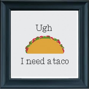 May include: White cross-stitch embroidery with the text "Ugh I need a taco" and a cartoon image of a taco.