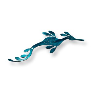 May include: A teal blue seahorse silhouette with a leafy design. The seahorse is made of metal and has a shiny finish.