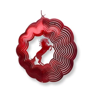 May include: A red metal wind spinner featuring a rearing unicorn silhouette within a layered, scalloped frame. The design is suspended by a thin cord, creating a dynamic, decorative element for outdoor spaces.