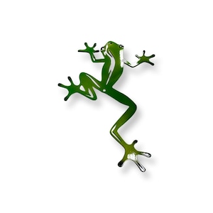 May include: Green metal frog wall art with a detailed silhouette design. The frog is in a leaping pose with its legs outstretched.