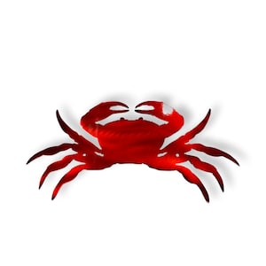 May include: A red metal crab silhouette wall decor. The crab is facing forward with its claws raised. The metal is textured and has a shiny finish.