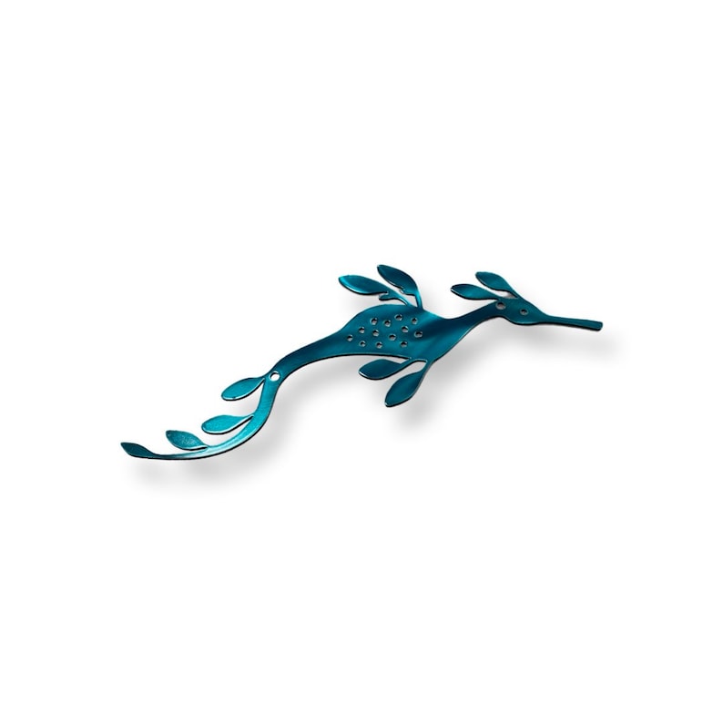 May include: A teal blue seahorse silhouette with a leafy design. The seahorse is made of metal and has a shiny finish.