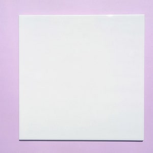 May include: A white square card on a light purple background.