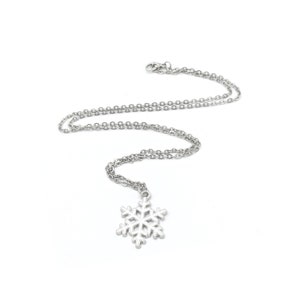 May include: A silver snowflake pendant necklace with a delicate chain.