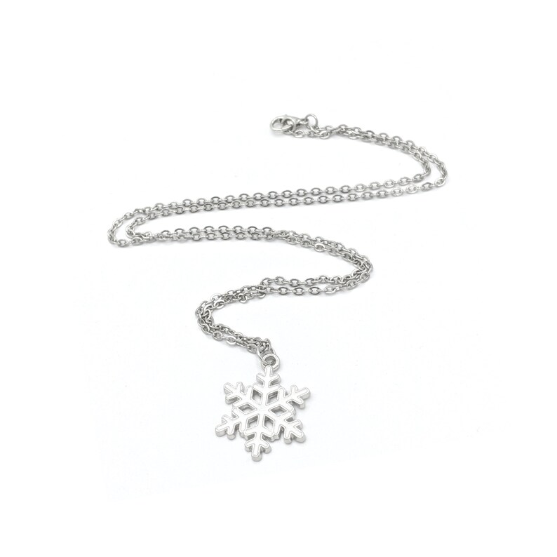 May include: A silver snowflake pendant necklace with a delicate chain.