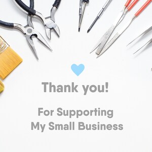May include: A white background with a blue heart and the text "Thank you! For Supporting My Small Business".  Surrounding the text are various tools, including pliers, tweezers, paintbrushes, and a file.