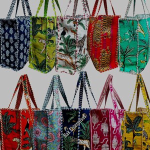 May include: Ten colourful tote bags with different animal and floral patterns. The bags are made of quilted fabric and have a patchwork design. The bags are all lined up in a row, with the handles facing up.