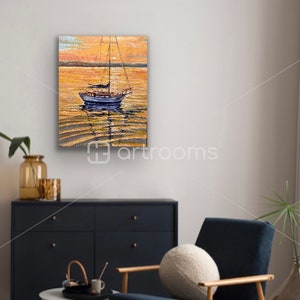 May include: A painting of a sailboat on a calm body of water at sunset. The water is a golden color and the sky is a soft orange. The sailboat is white with a blue hull and has a brown sail.