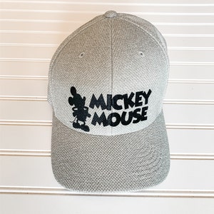 May include: A gray baseball cap with a black Mickey Mouse silhouette and the text "Mickey Mouse" on the front.