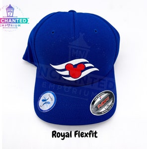 May include: A royal blue baseball cap with a white Mickey Mouse silhouette and three white waves on the front. The cap has a black Flexfit label on the side.