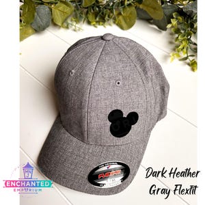 May include: Dark heather gray Flexfit baseball cap with a black Mickey Mouse silhouette embroidered on the front. The cap has a curved brim and a structured crown.