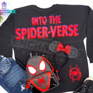 May include: Black long-sleeved shirt with the text "Into the Spider-Verse" in red and purple lettering. A black backpack with a red spider-man design, a black headband with red glitter mouse ears, and a red spider-man symbol are also pictured.