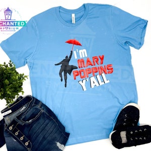 May include: A light blue t-shirt with a graphic of a person holding an umbrella and the text "I'm Mary Poppins Y'all".