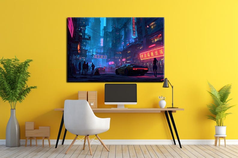 May include: A canvas print depicting a futuristic cityscape at night. Neon signs illuminate the streets, with a yellow sports car and silhouetted figures. The artwork is displayed on a yellow wall above a desk with a computer monitor and a white chair.