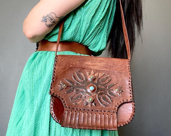 Featured listing image: 1970s two toned tooled leather satchel bag with gemstone inserts.