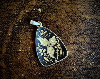 1970s black & golden pendant amulet.