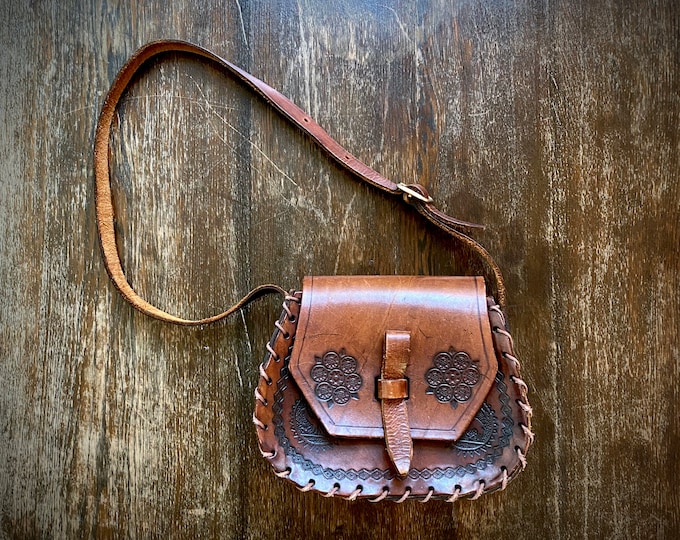 Featured listing image: 1970s tooled leather satchel bag.