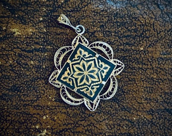 1970s black & golden filigree pendant.