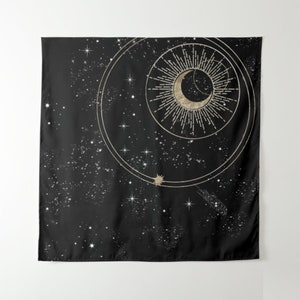 May include: A black tapestry featuring a gold crescent moon and sun design. The moon and sun are encircled by a ring of stars and a gold ring.