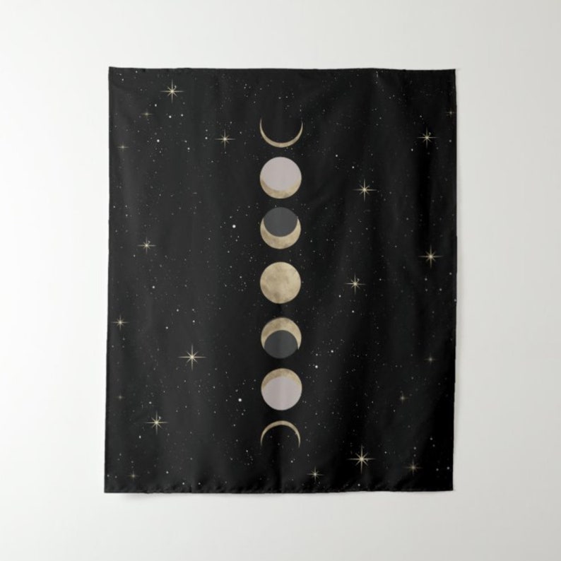May include: A black tapestry with a white and gold moon phases design. The tapestry features a series of moons in different phases, from a crescent to a full moon, against a starry night background.