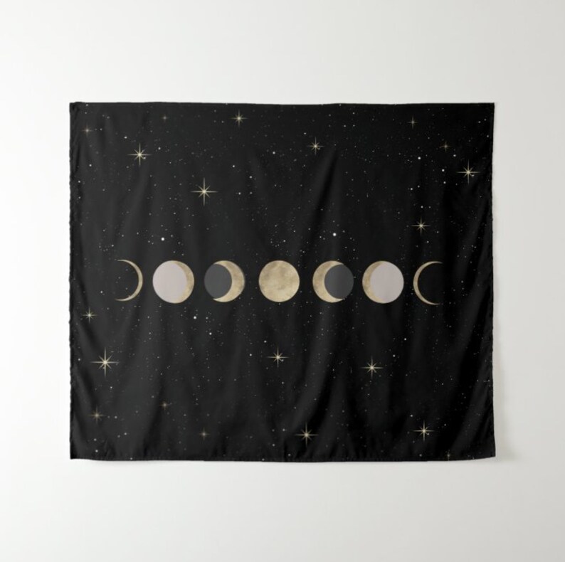 May include: A black tapestry with a gold and gray moon phases design on a black background with gold stars.