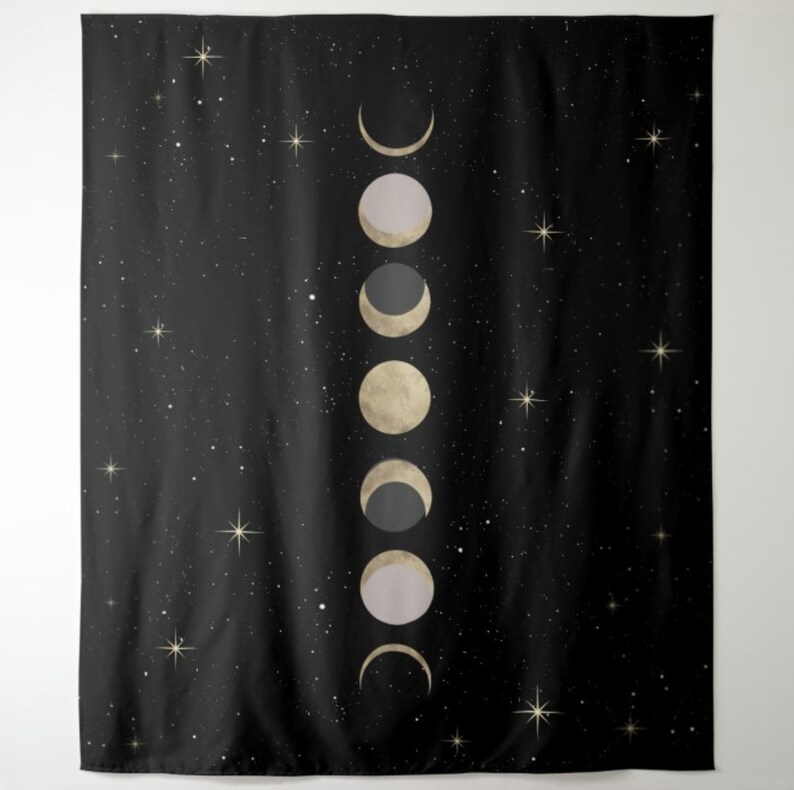 May include: A black tapestry with a white starry night sky background and a vertical row of gold and gray crescent moons.