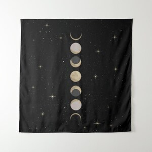 May include: A black tapestry with a white and gold moon phases design on a black background with white stars.