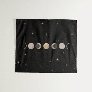 May include: Black tapestry with a gold and white moon phase design on a black background with white stars.