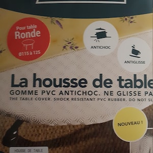 May include: A white and brown round table cover with the text "La housse de table" and "GOMME PVC ANTICHOC. NE GLISSE PAS" in black. The table cover is 135 cm in diameter and is labelled "NOUVEAU!" in yellow. The product is made in France.