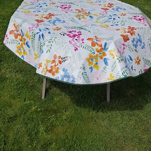 Round oilcloth 155cm wide with flowers.