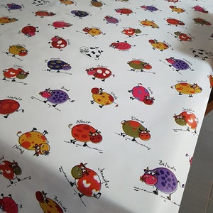 Oilcloth 140 cm wide multi-colored cows.