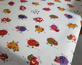 Toile cirée en 140 cm de large "Les vaches multi-couleurs ".