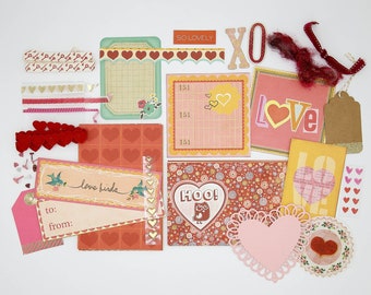 May include: A collection of Valentine's Day themed paper crafting supplies, including patterned paper, die cuts, stickers, and embellishments. The supplies feature hearts, birds, owls, and the words "love birds" and "hoo!" in a red, pink, and gold color scheme.