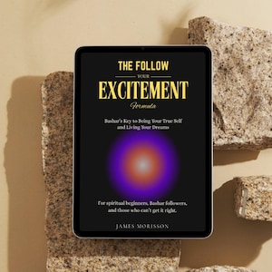 May include: A digital tablet displays the book cover for "THE FOLLOW YOUR EXCITEMENT FORMULA" by James Morisson. The cover features gold text on a black background, with a purple and orange circular design. The tablet rests on a textured, light brown surface.