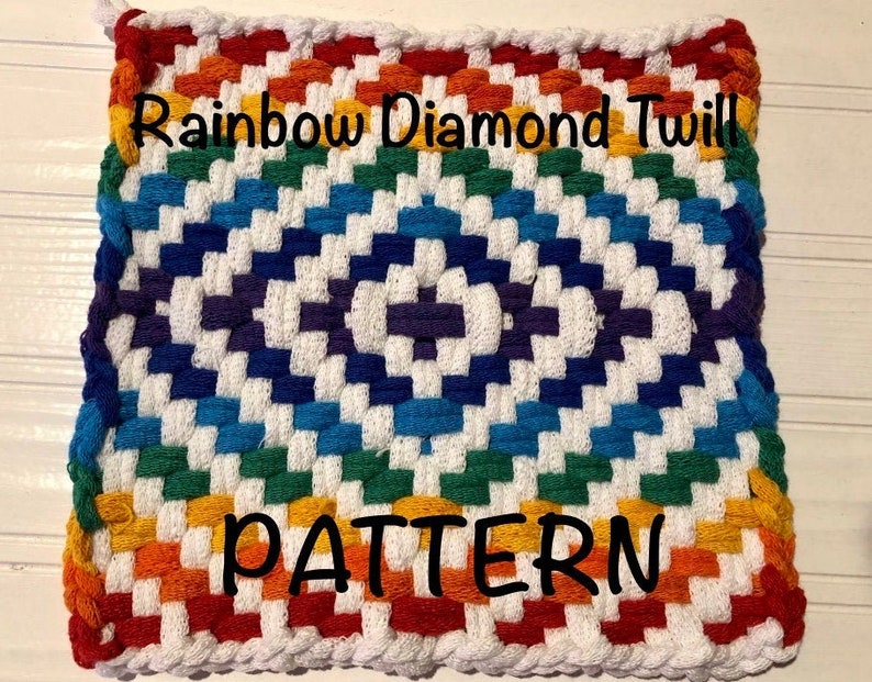 May include: A rainbow colored crochet pot holder with a white background and the text "Rainbow Diamond Twill PATTERN" in black.