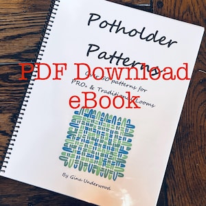 May include: A spiral-bound book titled "Potholder Patterns" with the text "PDF Download" and "eBook" in red. The cover features a geometric design in blue and green. The book is on a wooden surface.