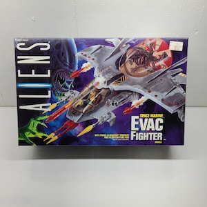 May include: A gray and white space marine Evac Fighter toy with firing Alienator missiles and an Alien Capture Pod. The toy is from the Aliens movie franchise.