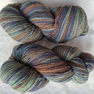 Wollgarn zum Stricken. Hochwertiges multicolor blau, braun, gestreiftes Garn aus 100 % Wolle. Natürliches Lanolin-Garn.