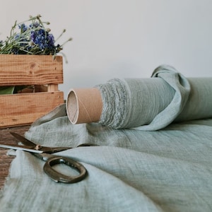 May include: A set of three ceramic mugs with a speckled, matte finish. The mugs are in shades of cream, light gray, and dark gray. Each mug has a simple, minimalist design, perfect for coffee or tea.